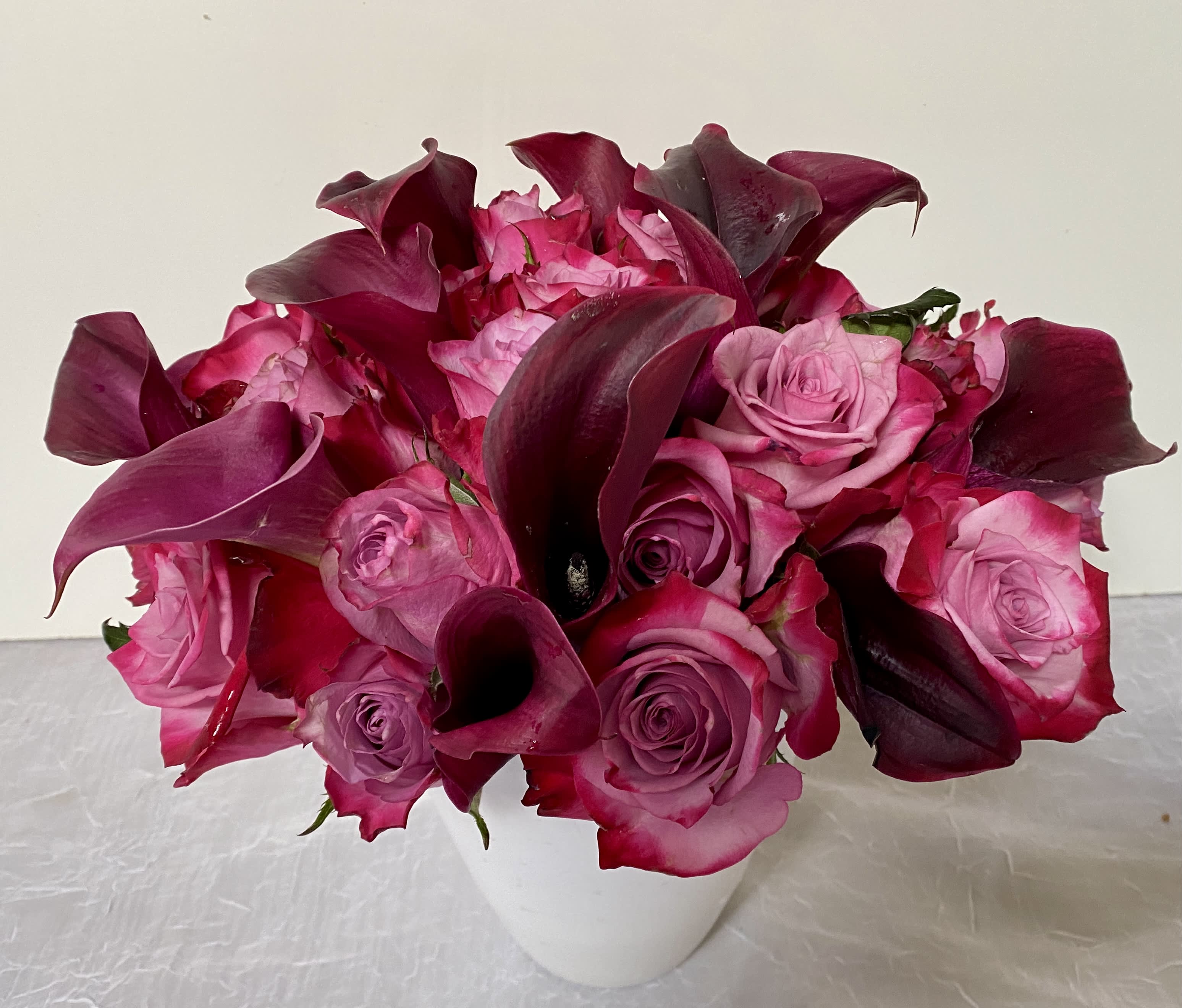 BROOKLYN - in a beautiful vase arrangement of purple roses and purple calla lily.