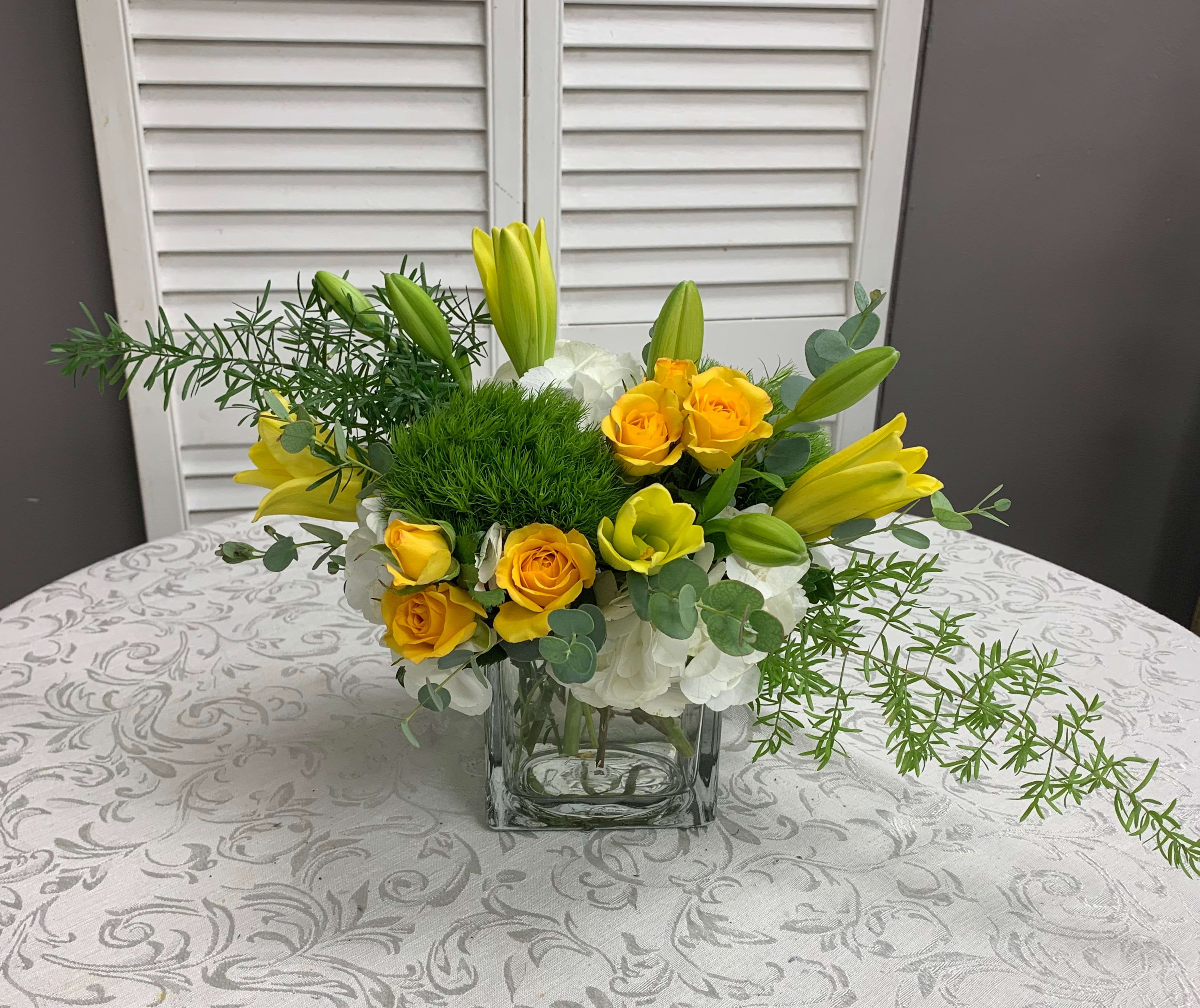 Sunshine Dreams - Arrangement is created with Hydrangeas, Lilies, Spray Roses and Dianthus.