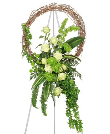 Fresh Green Inspirations - Our Fresh Green Inspirations arrangement provides a graceful monochromatic look that you can use to express your sympathy and compassion. We have dressed this arrangement with bells of Ireland, green roses, and green spider mums, as well as accenting it beautifully with a grapevine wreath.