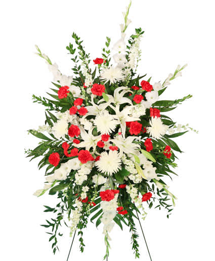 A Kiss Goodbye - Brighten a time of sorrow with a beautiful standing spray that highlights the beauty of fond memories. Traditional and timeless white lilies and red carnations in A Kiss Goodbye are perfect for any memorial, wake, or funeral service.