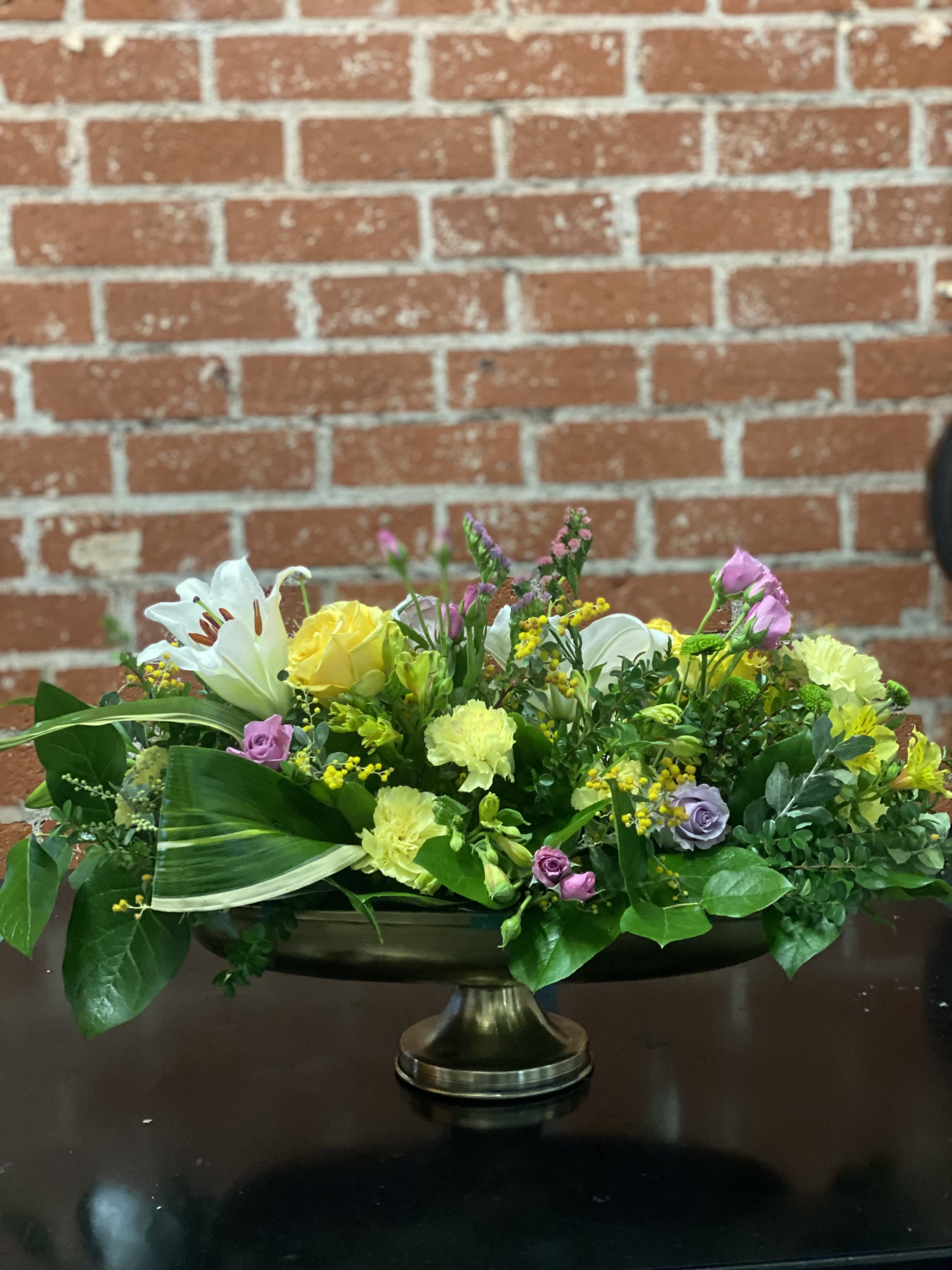Sleeping Beauty Sleeping Beauty - Yellow roses, miniature lavender roses, pink status, yellow carnations, yellow alstroemeria, and aspidistra leaves.