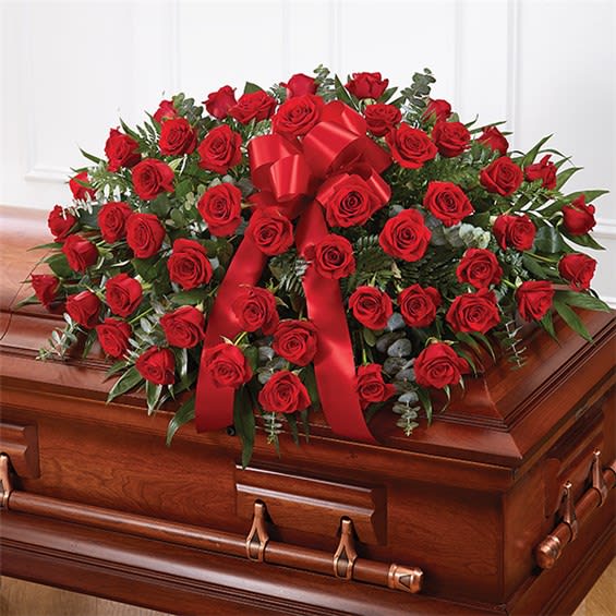  Red Rose Half Casket Cover - When someone near and dear to us passes, it’s natural to want to express all the love and admiration we have in our hearts. Nothing conveys this better than a classic display of red roses. Our half casket cover, crafted with care and artistry by our expert florists with 50 premium red roses, fresh greenery, and accented with a red satin ribbon, is an unforgettable way to commemorate a lifetime of esteem and adoration. Please give us at last 36 hours for this one. Please specify in Special instructions if you prefer it in different color flowers.