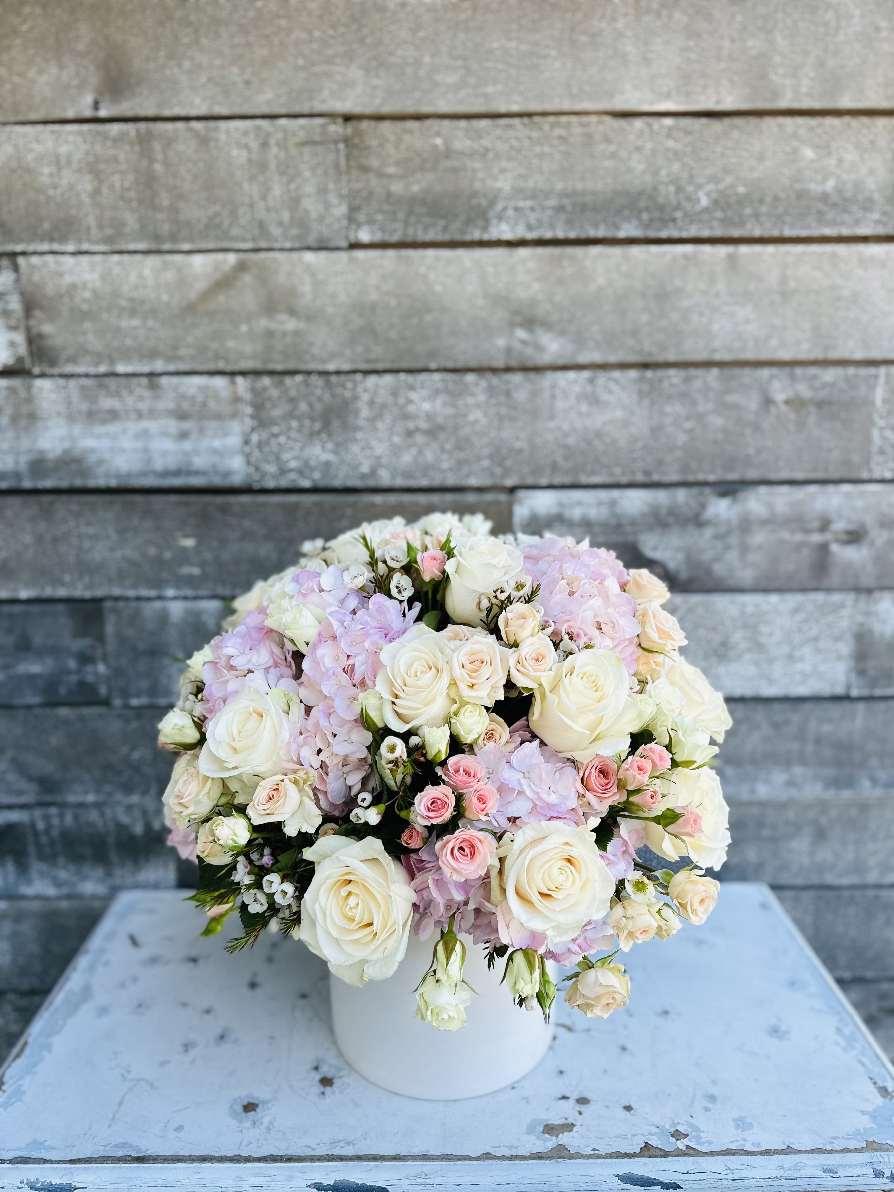 Blushing blossoms Blushing blossoms - Blush whites and gorgeous blossoms or roses and hydrangea and a chic clean white container
