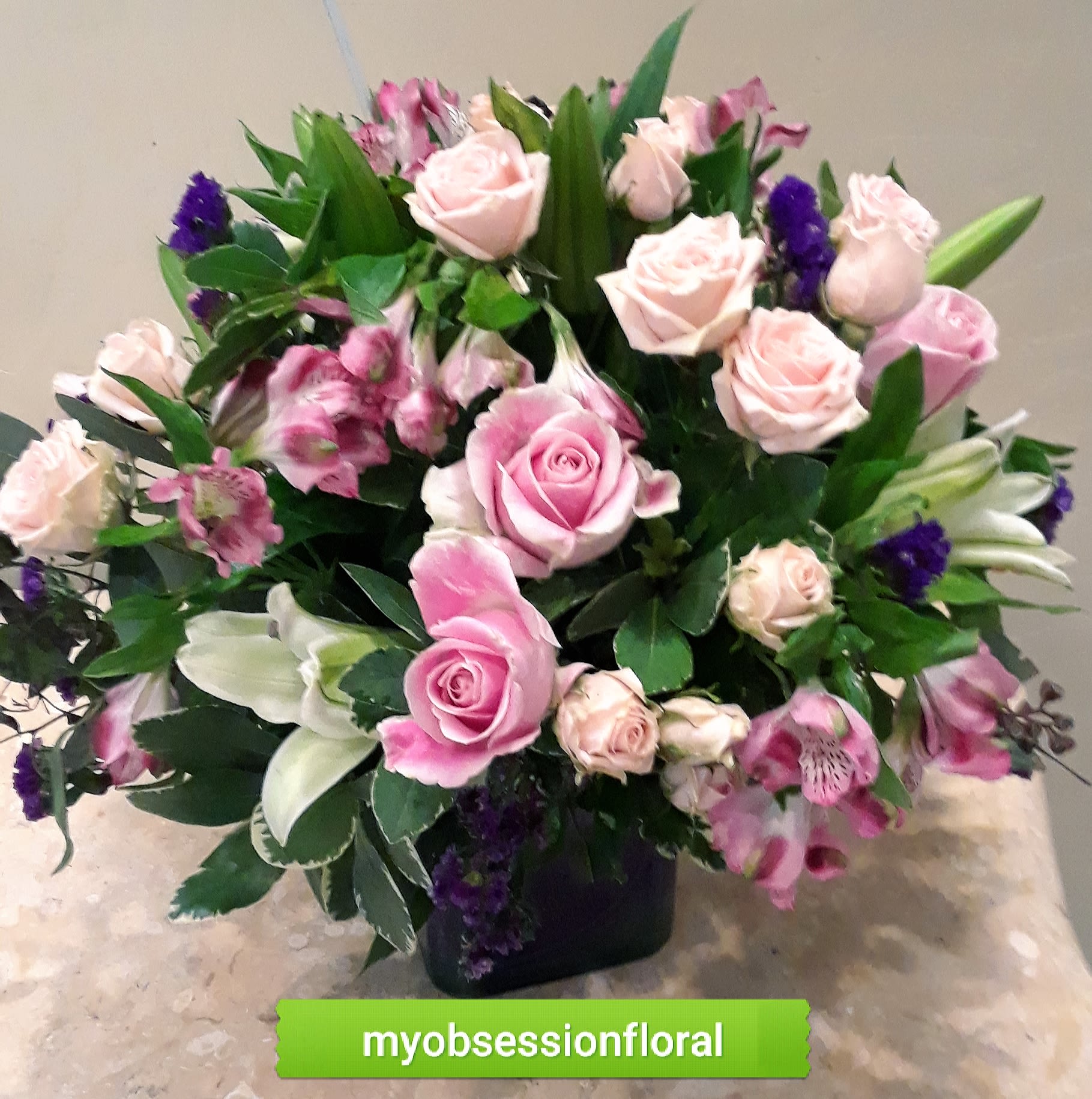 Cube with pinks and purples. - Roses, lilies, alstromeria, and purple filler, arranged tight and low in a cube vase. It is so pretty!