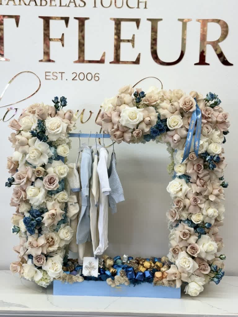 Welcome baby boy  - We are excited to introduce our latest addition, a stunning floral arrangement shaped as a closet. This beautiful piece will add a touch of elegance and sophistication to any room. Please note that we do not provide the clothing, racks, or chocolate shown in the product images. Our focus is solely on providing our customers with the highest quality floral arrangements. We take pride in our attention to detail and commitment to excellence. Order yours today and experience the beauty of our floral artistry!