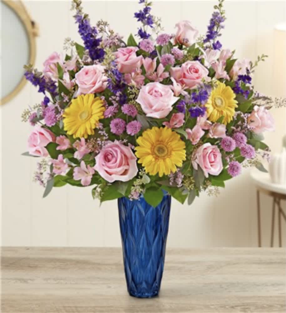 TO A MOM WHO IS BEUTIFUL -  Our garden-gathered bouquet features a mix of blooms in blush pink, soothing purple and cheerful yellow. Designed in our Blue Harmony vase, with striking color and exquisite texture, it’s a gift to captivate their senses while delivering your sentiments in a beautiful way. All-around arrangement with yellow Gerbera daisies, pink roses, Peruvian lilies (alstroemeria) and Limonium, purple larkspur, lavender button poms; accented with seeded eucalyptus and assorted greenery Artistically designed in our Blue Harmony vase with decorative textured glass in cobalt blue; a stylish keepsake that enhances the natural beauty of fresh floral bouquets; measures 9.5&quot;H x 5&quot;D Large arrangement measures approximately 30&quot;H x 18&quot;W Small arrangement measures approximately 29&quot;H x 16&quot;W Our florists hand-design each arrangement, so colors and varieties may vary due to local availability To ensure lasting beauty, Peruvian lilies may arrive in bud form and will fully bloom over the next few days
