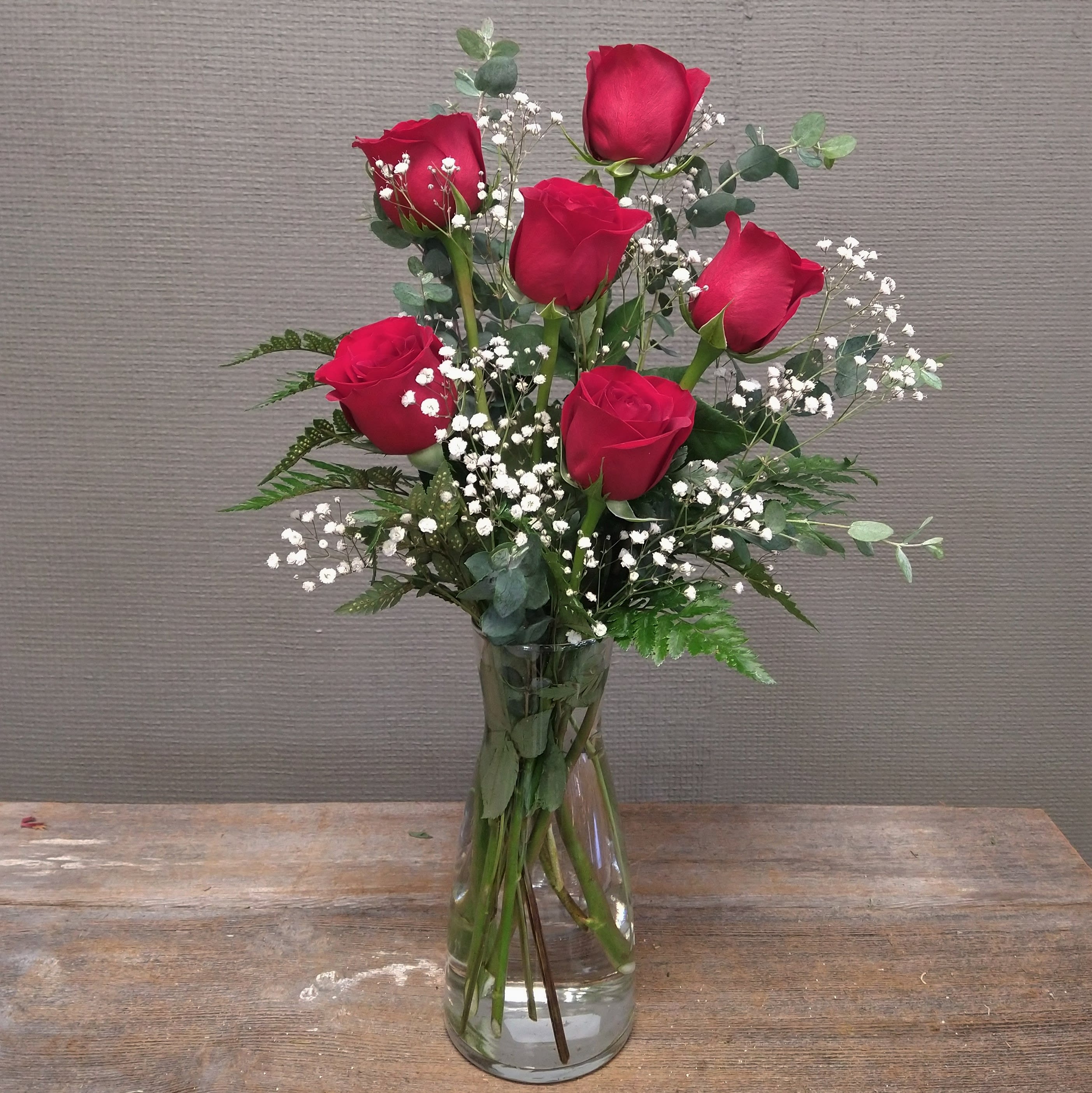 Half of My Heart - A half dozen red roses with greens and filler. A taller presentation of 6 roses. Great for smaller spaces. Please specify if you would like a different color.