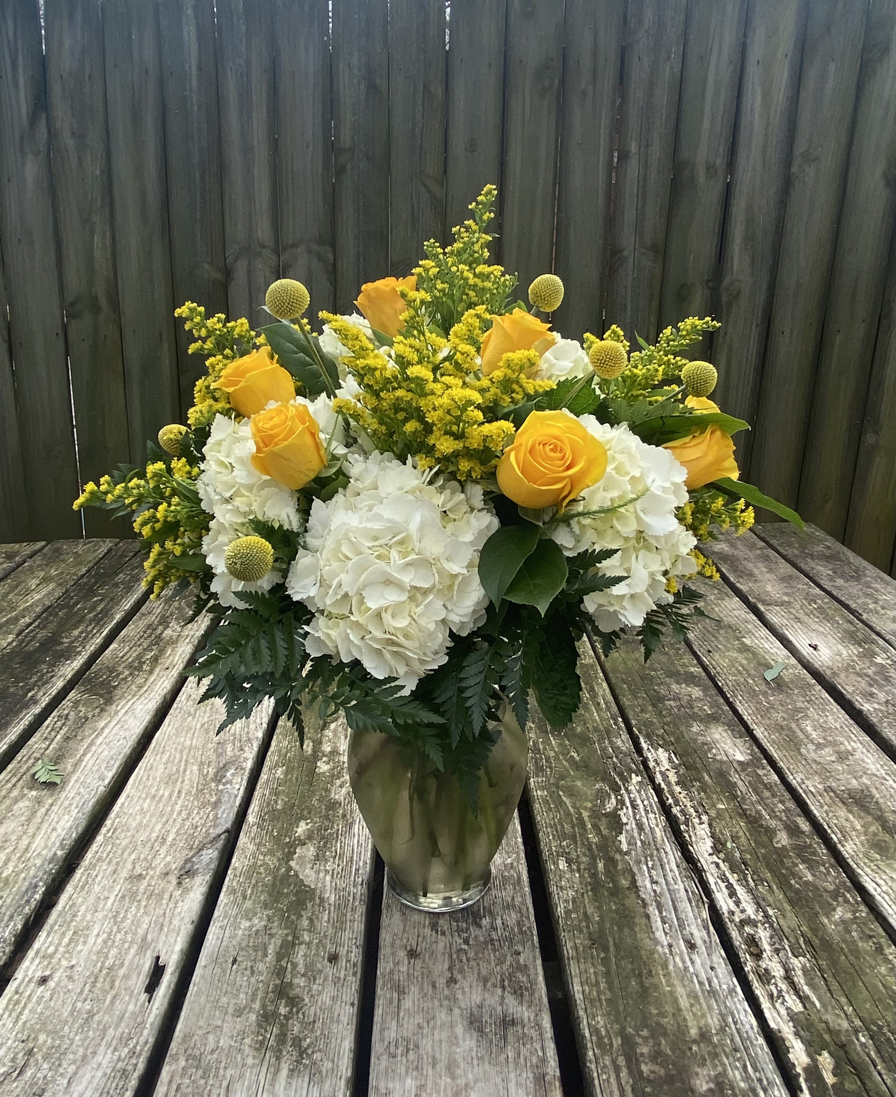 Sunshine and Lollipops  - Yellow roses and craspedia with white hydrangea in a glass vase