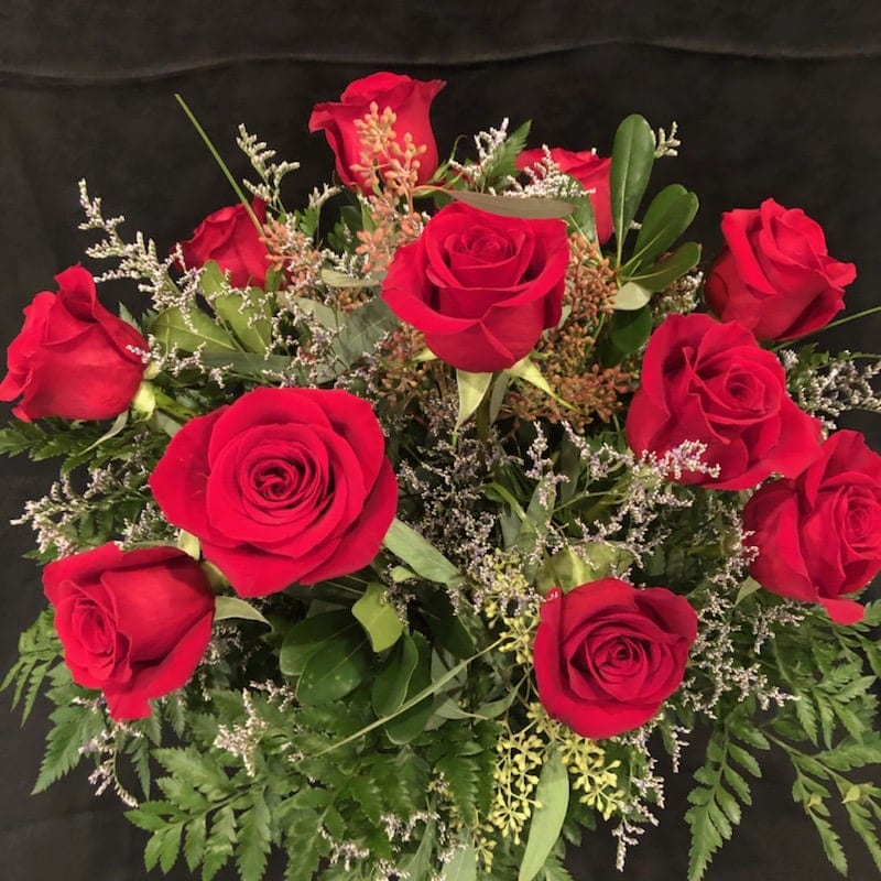 Love And Roses - 1 Dozen long stem red roses, accent flower, and greenery arranged in a glass vase 