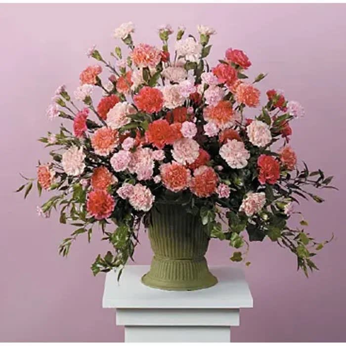 Carnation Tribute Carnation Tribute - Mache vase with all carnations and mini carnations in shades of pink and red.