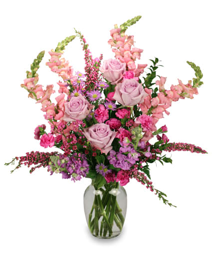 You're Still the One - This beautiful tall arrangement has pink roses with hot pink carnations, pink alstromeria, pink snapdragons, lavender asters, pink wax flowers nestled in variegated/dark green greenery 