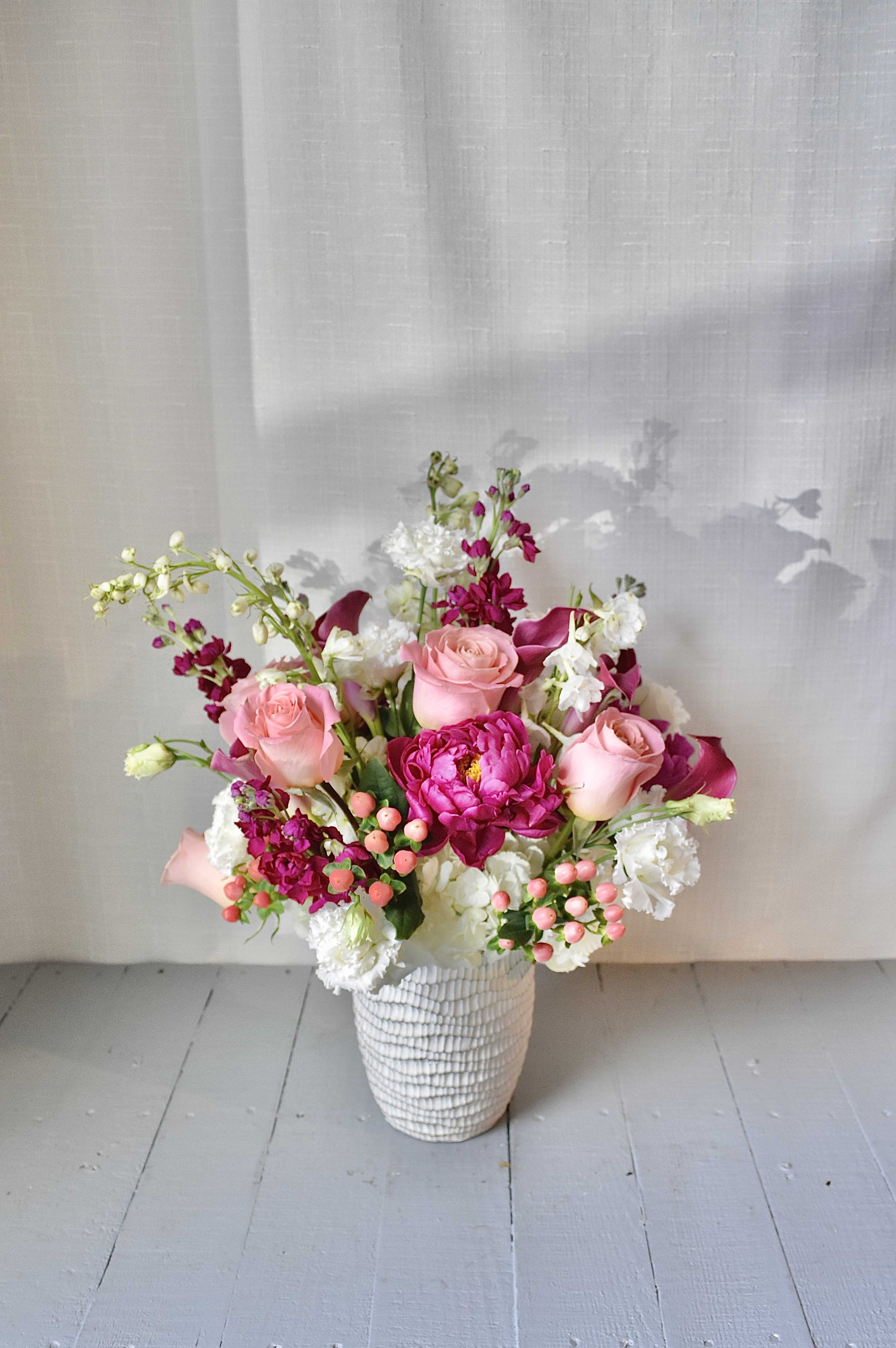 Hearts Aflame - A luxurious pastel floral design for every occasion, Hearts Aflame is a medium lush arrangement composed of roses, stock, callas and seasonal locally sourced flowers. 