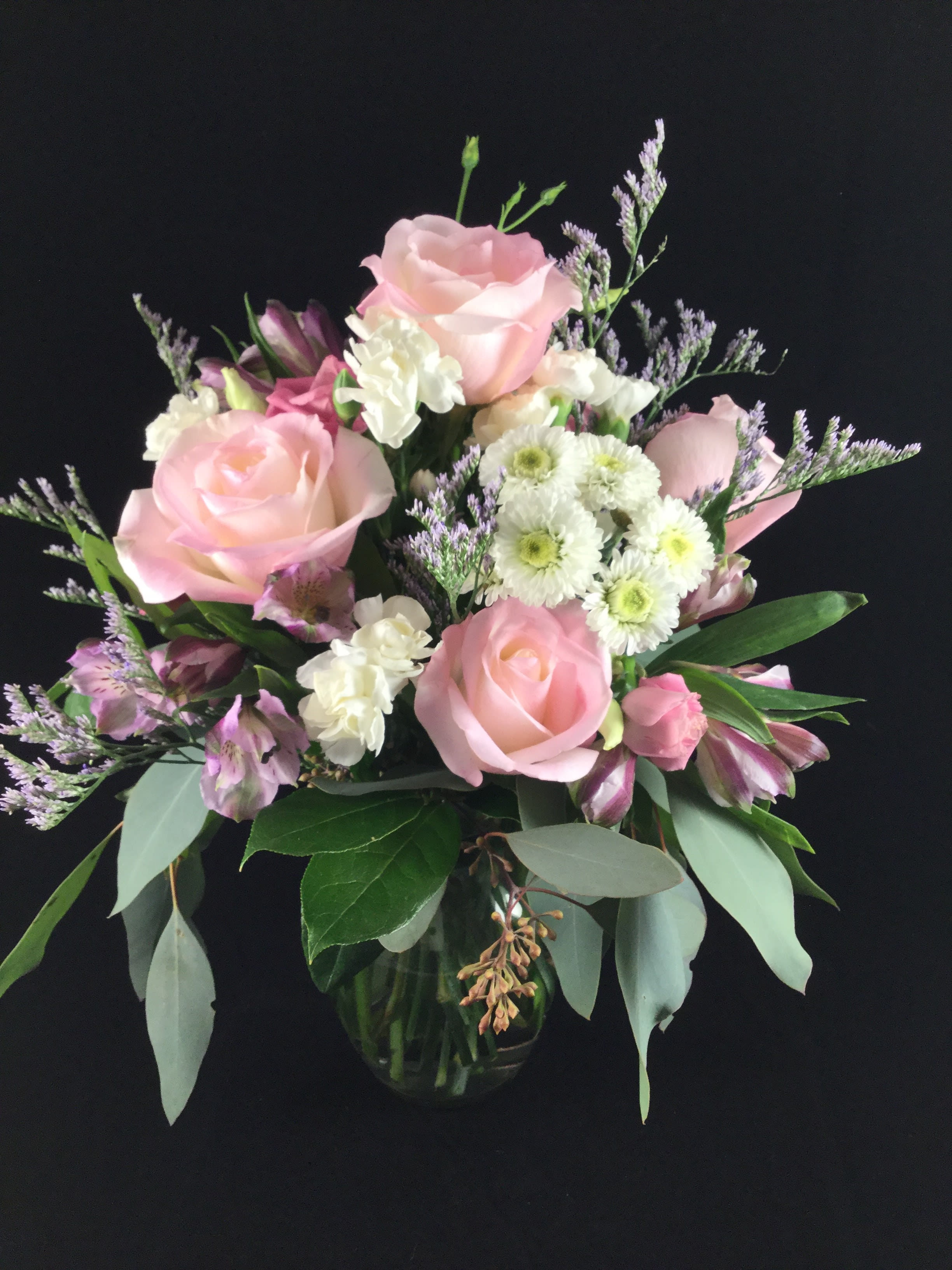 Kiss and Tell - Beautiful pink roses with an assortment of other seasonal favorites. 