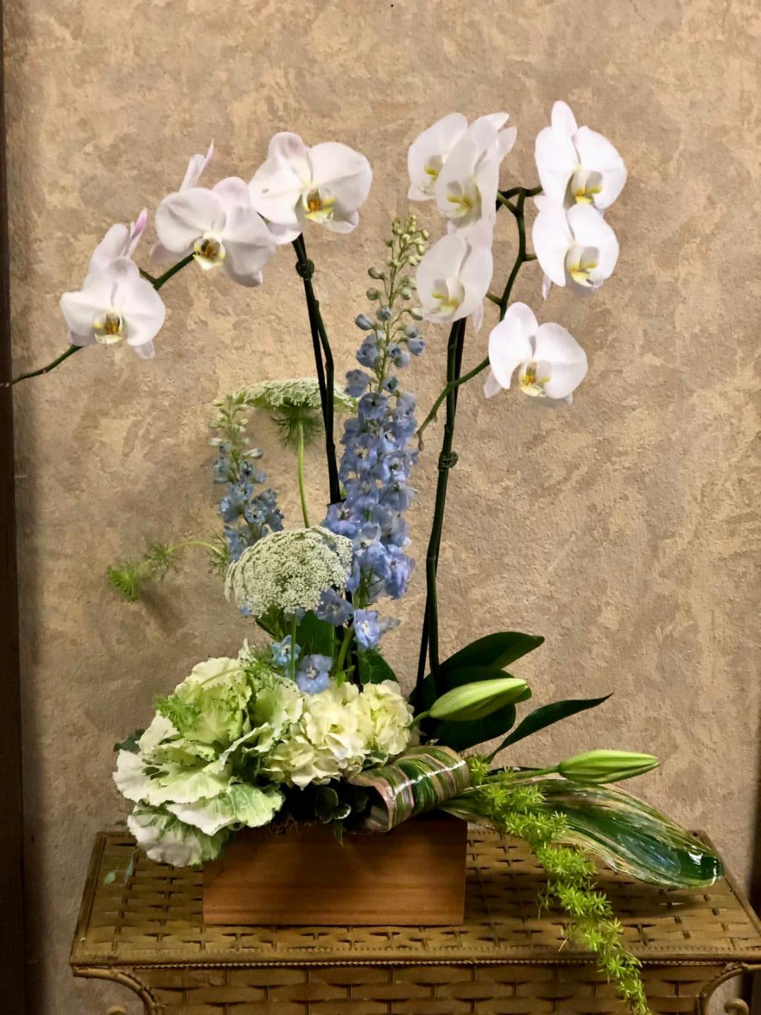 Earth Month 2024 Special - In honor of Earth day, this arrangment was design for the purpose to reuse and repot. This arrangement contains with double-stem orchid plant, fresh cut flowers, and cabbage in a handmade wooden box.