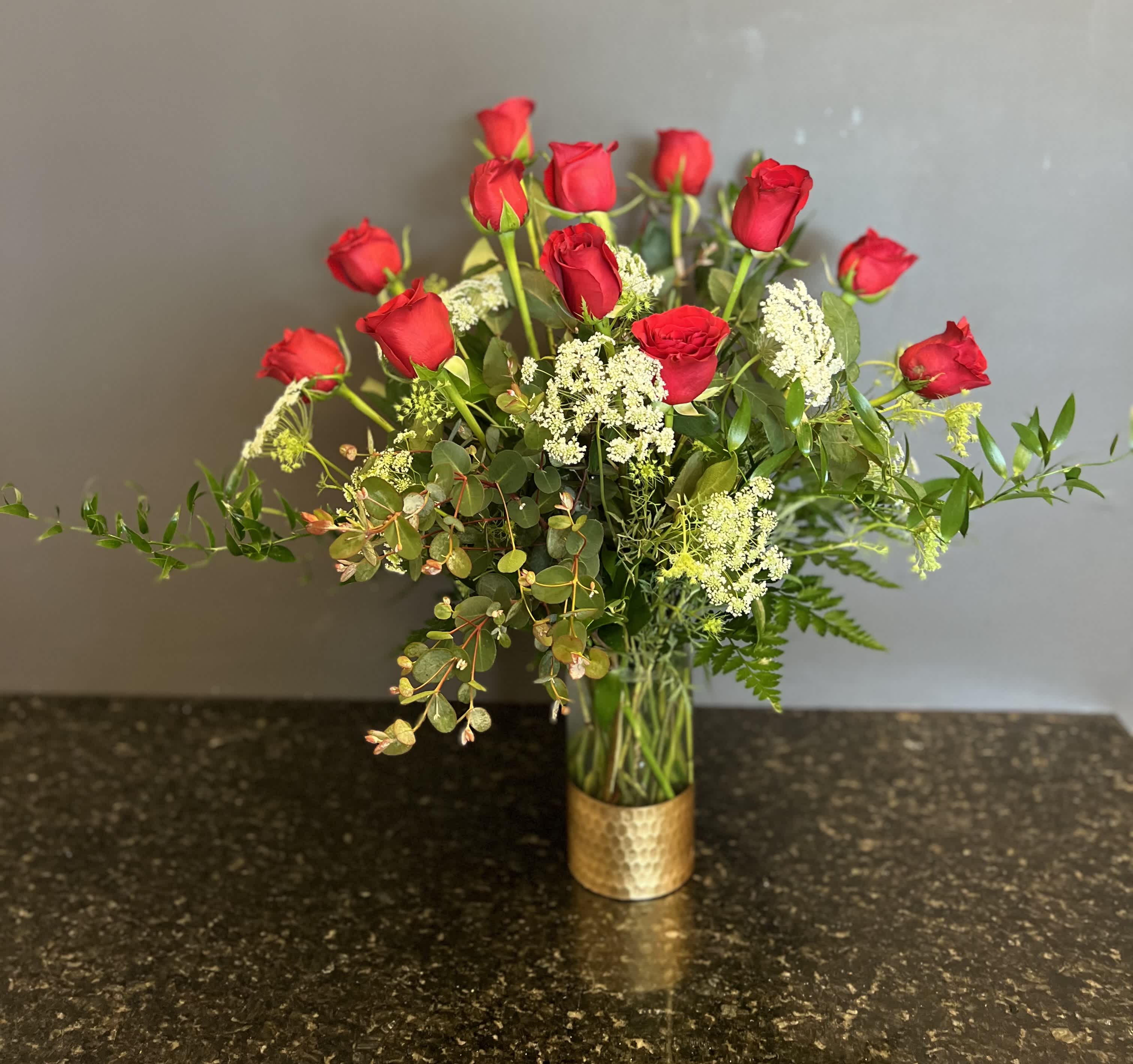 Elegant Dozen Roses - 12 long stem red roses arranged in a designer gold bottomed vase with premium greenery and filler for the extra elegant and classy look