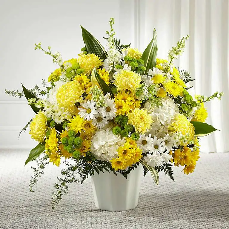 Unity & Grace Floor Basket Unity & Grace Floor Basket - Every bloom in our Unity & Grace™ Floor Basket reminds us of the brightness of their spirit. This stunning arrangement features an uplifting mix of hydrangea, larkspur, daisy pompons and mums. Each arrangement is handcrafted and hand delivered by a local florist, making it a touching gesture for loved ones.