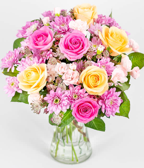 Sweet Spring bouquet - A beautiful mix of pink and cream roses, chrysanthemums and spray carnations, complemented with delicate foliage. 