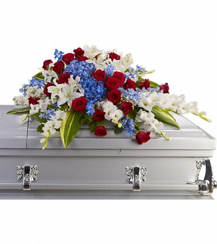 Distinguished Service Casket Spray -  A beautifully patriotic way to pay tribute to a loved one. This half-couch spray sends an eloquent message of strength respect and freedom. Brilliant flowers such as blue hydrangea red roses white oriental lilies and much more create this dignified way to honor the deceased.  Approximately 46 1/2&quot; W x 24&quot; H Orientation: N/A