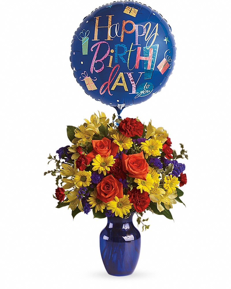 Fly Away Birthday Bouquet - Make birthday spirits soar by sending this fabulously fun birthday bouquet and balloon. Bright primary colors make it perfect for guys and gals. Years may fly by but that doesn't mean birthday celebrations need to! Brilliant orange roses yellow alstroemeria red carnations and miniature carnations yellow daisy spray chrysanthemums purple statice and a big bright balloon are all delivered in a beautiful cobalt blue vase. It's a thumbs-way-up choice in birthday gifts!