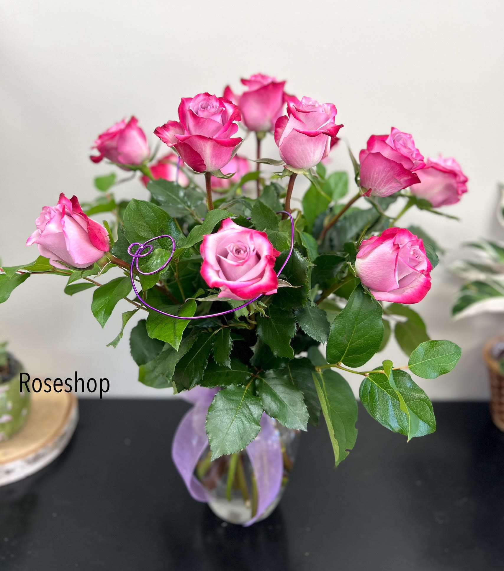 Dozen Long Stemmed Lavender Roses Dozen Long Stemmed Lavender Roses - This arrangement is the perfect "pick me up" to brighten someone's day. Dozen Long Stemmed Lavender Roses is the perfect gift for a birthday, get well, just because, and thank you. Arrangement Details: 12 Long Stemmed Lavender Roses and Assorted Greenery APPROXIMATE DIMENSIONS: 20" H X 16" W