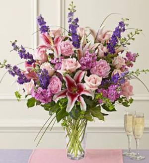 Abundant Love in Purple - EXCLUSIVE Admiration and love. It's how you feel. And she'll understand it, abundantly, when this array of pink long-stem roses, larkspur, lilies, and more arrives. It comes hand-arranged in a stylish clear glass vase.  Luxury arrangement of long-stem pink roses, larkspur, lilies, peonies, stock, bupleurum, salal and bear grass, beautifully hand-designed by our select florists Large arrangement measures approximately 28&quot;H x 20&quot;D Small arrangement measures approximately 26&quot;H x 18&quot;D does not include peonies. Our florists select only the freshest flowers available so floral colors and varieties may vary