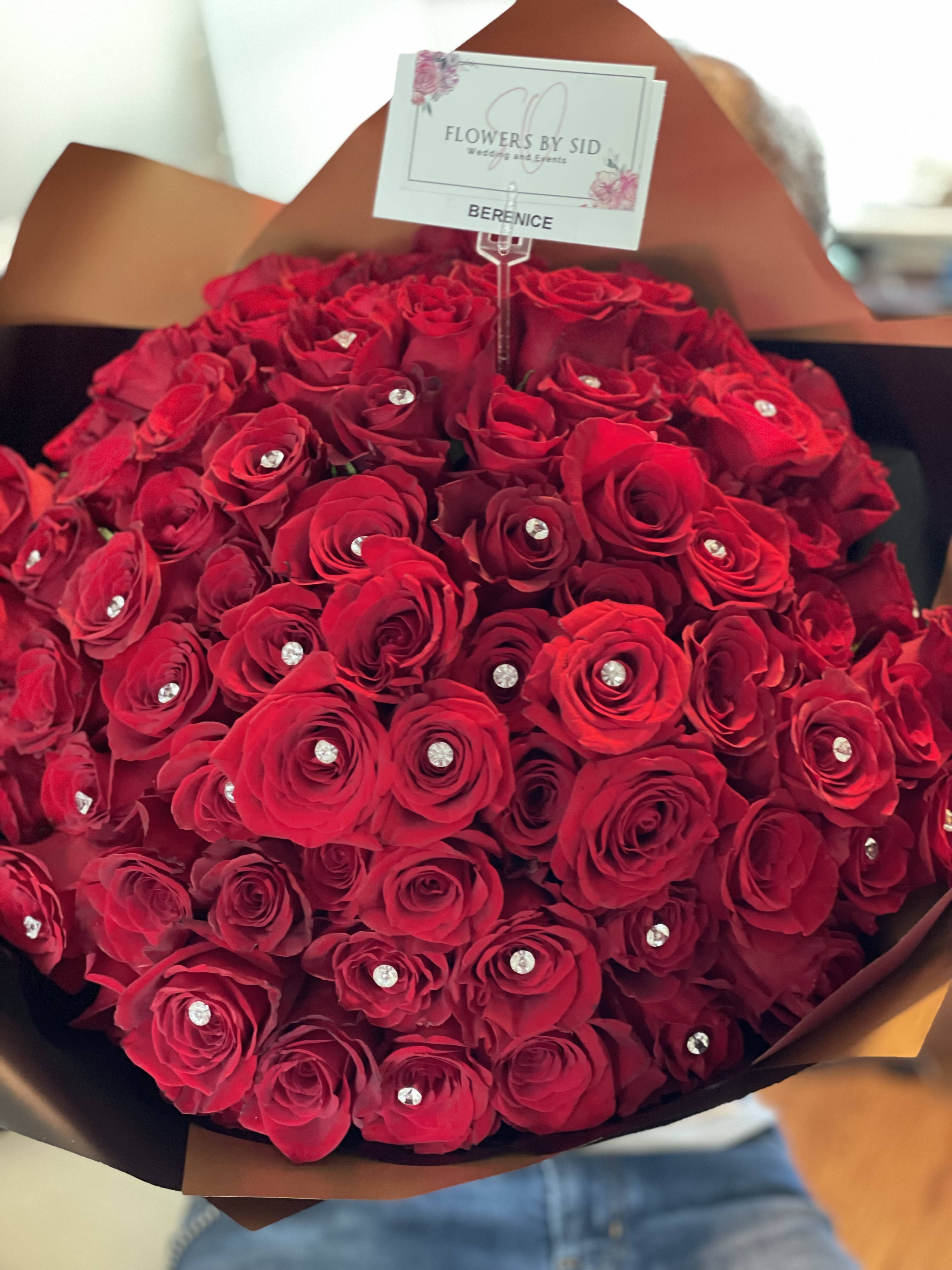 Red Buchon - Hand tied bouquet of red premium roses. Add ons are available  Starting 25 stems.