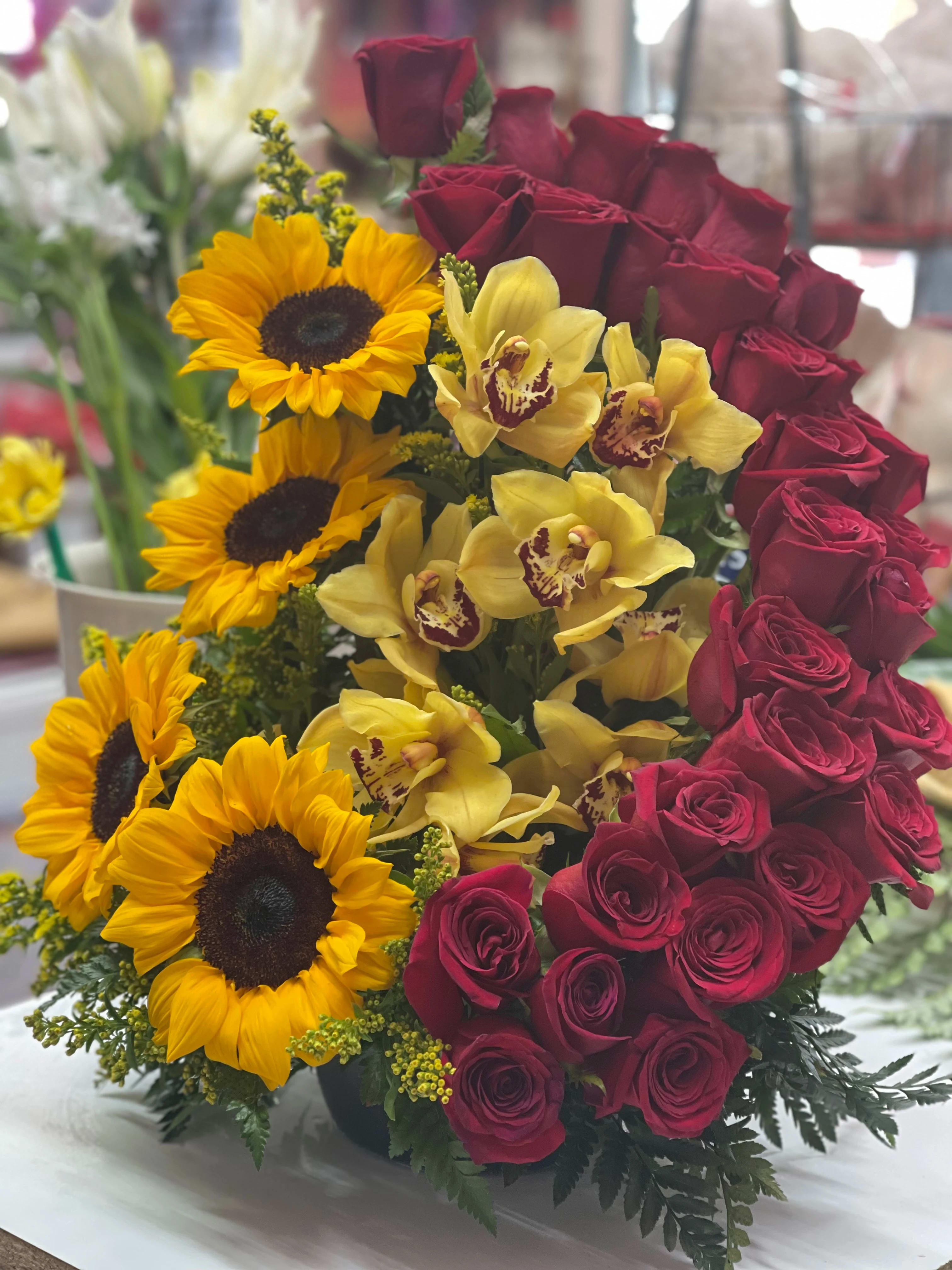 Paradise  - Blushing shades of pink blooms are nestled in lush greens to charm anyone's day. This bouquet is abundant with a classic assortment of pretty florals – roses, alstroemeria and carnations to name a few.