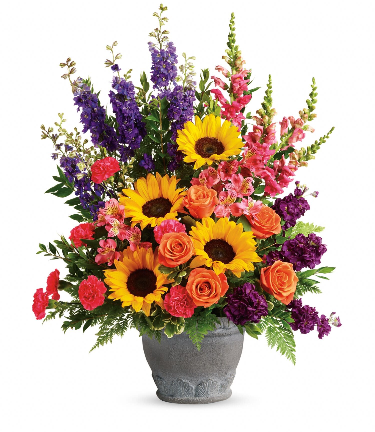 Hues Of Hope Bouquet - T279-1B: A colorful reminder that brighter days are ahead, this uplifting arrangement of sunflowers and roses in an elegant large antiqued pot brings joy and hope.  This bright arrangement includes orange roses, pink alstroemeria, hot pink carnations, yellow sunflowers, purple larkspur, purple stock, hot pink snapdragons, myrtle, variegated pittosporum, and leatherleaf fern. Delivered in a Parisian Garden Pot.   Approximately 23&quot; W x 30&quot; H Orientation: One-Sided As Shown: T279-1B