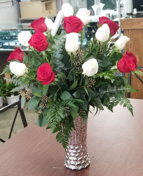 Two Dozen Roses -- Red and White - Sometimes more is more! Double your display of affection with 24 long stemmed roses, a beautiful balance of red and white. Bundled with lush greenery and arranged in our luxurious metallic vase.  Standard is as shown. Deluxe adds accent flower. Premium adds curly willow and Oriental lilies.