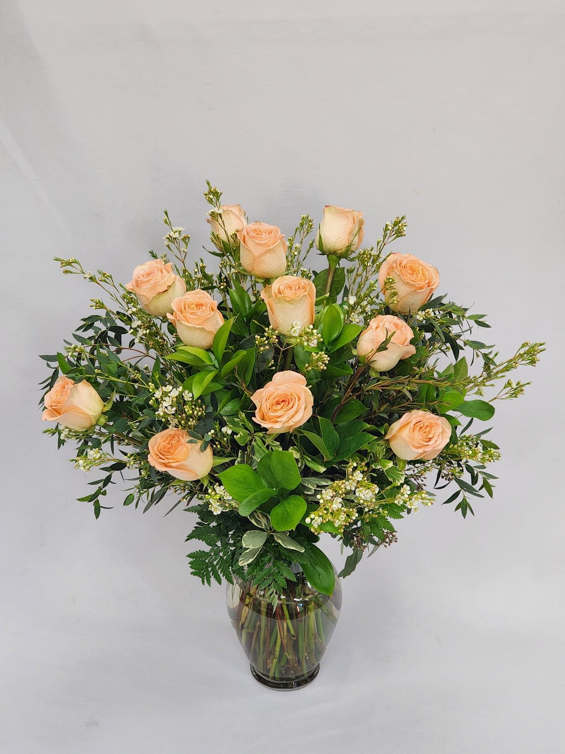 Long Stem Dozen Peach Roses - This arrangement if filled with one dozen long stem peach roses with filler and greenery. Filler flower will vary. 
