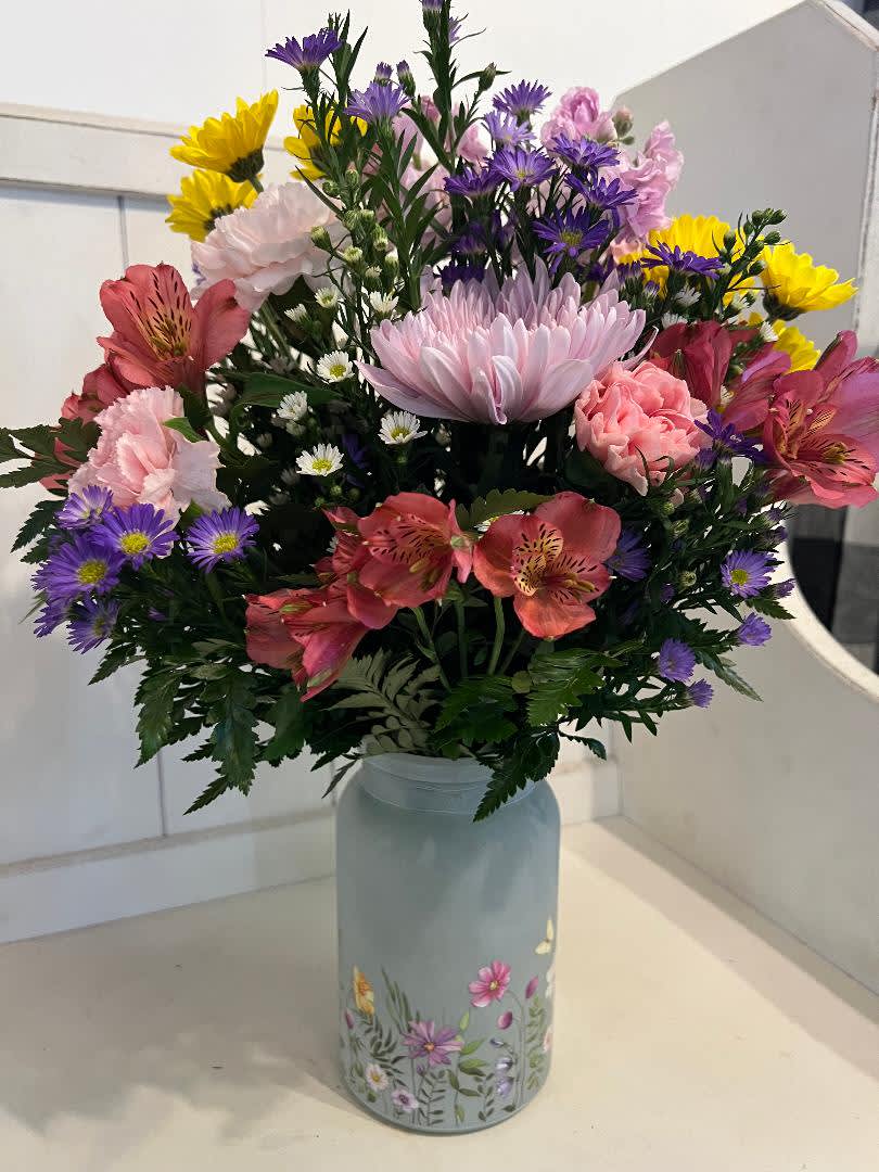 In My Garden - Beautiful mason jar style frosted vase, with flowers all around it. Filled with daisies, carnations, fillers, mum etc. great for a sweet surprise for a friend of loved one.