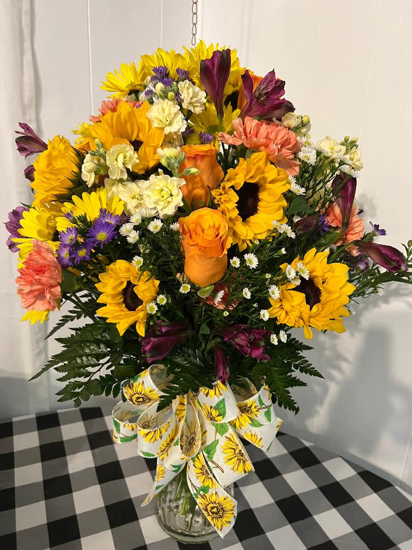 Nature's Bounty - Large vase filled with beautiful Sunflowers, Orange roses, filler, daisies, alstroemeria,  stock. If you upgraded the arrangement, it will include more flowers. 