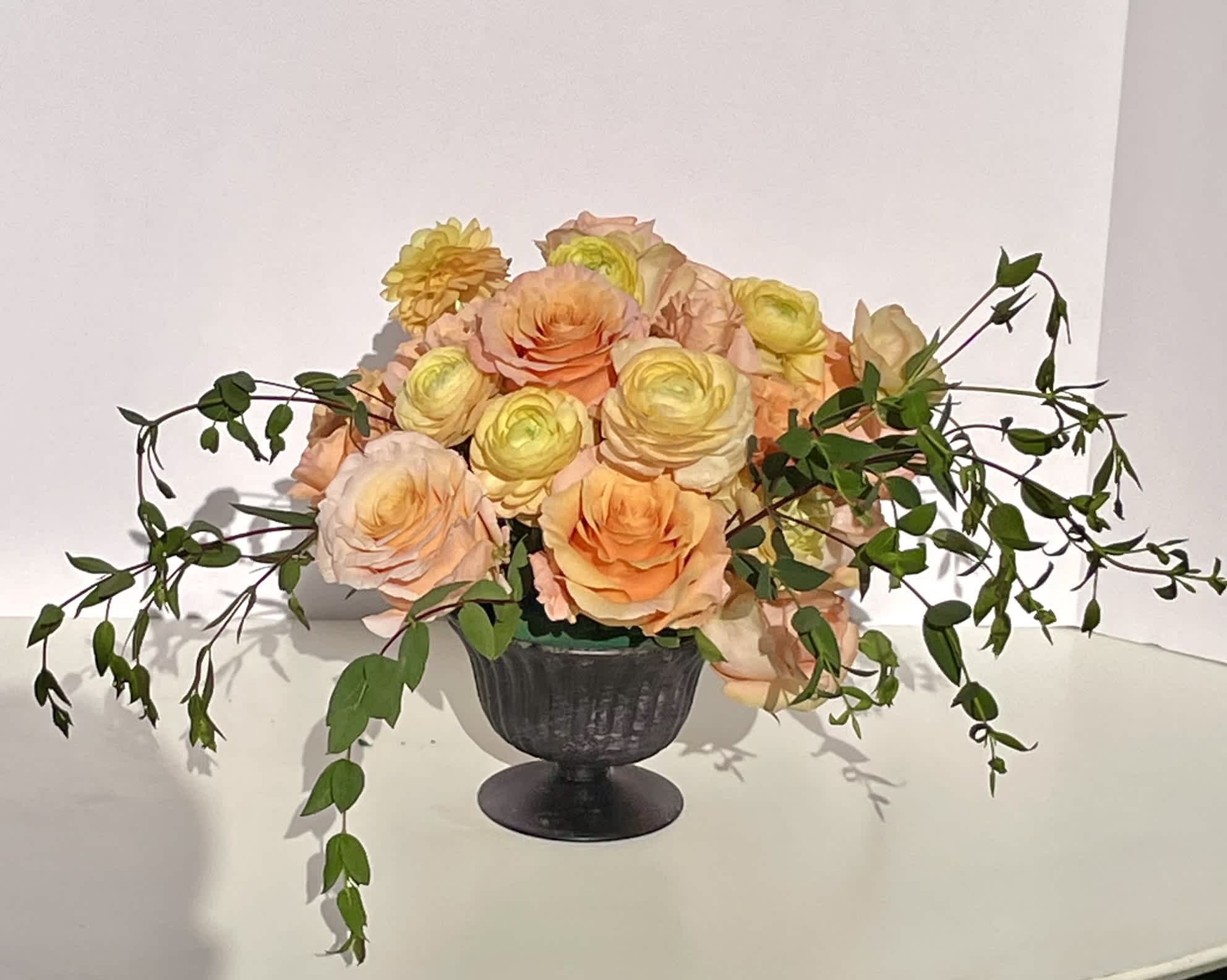 Tangerine Dream - This compact arrangement of ranunculus, roses, and garden roses is full of soft round blooms, each with incredibly unique textures. The hues of tangerine and peach make a bright and beautiful show like the first light of sunrise.