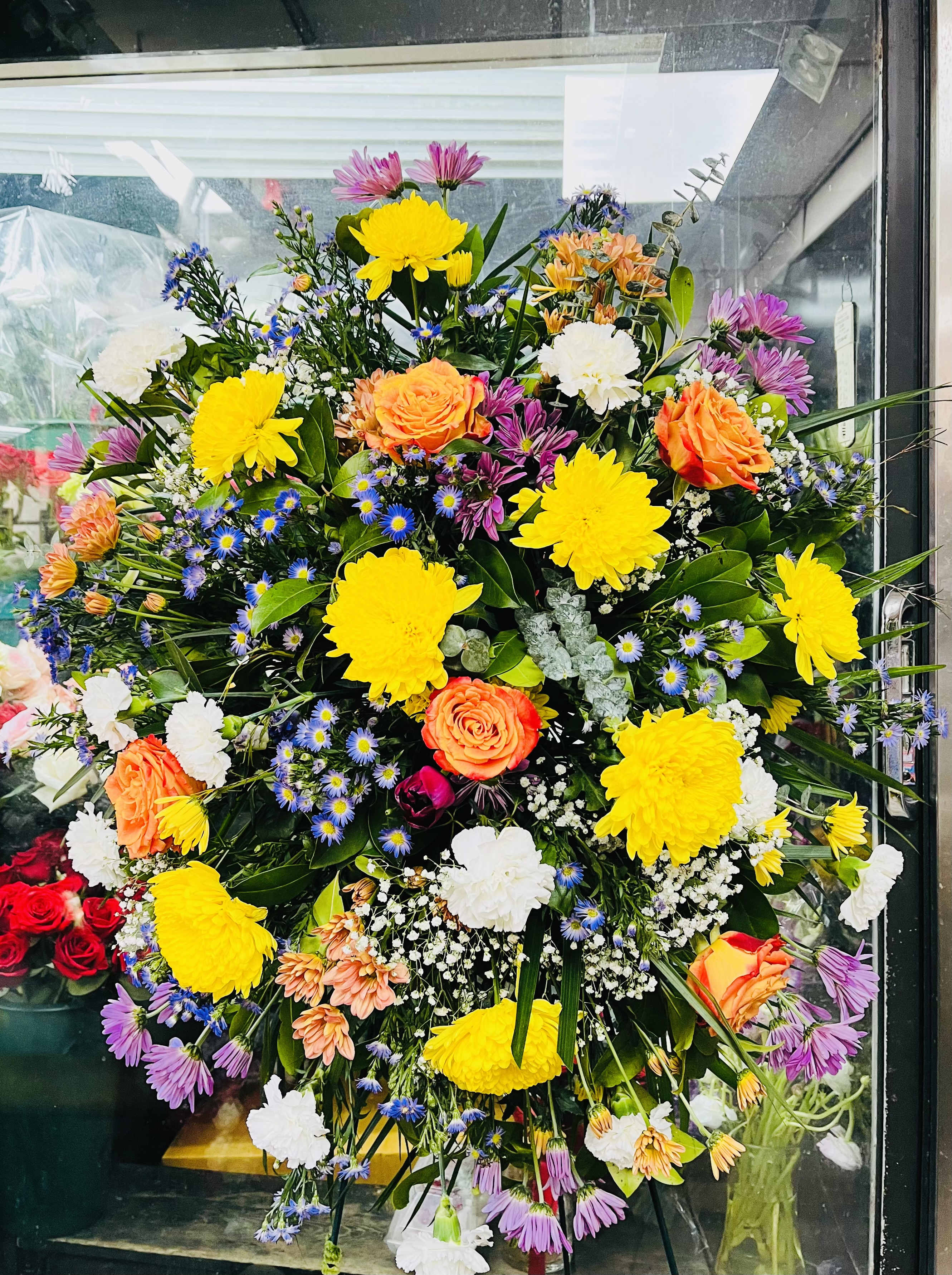 Sympathy Standing Spray 2 Sympathy Standing Spray 2 - Carnations • Chrysanthemums • Roses • Decorative Ribbon • Sympathy Stand