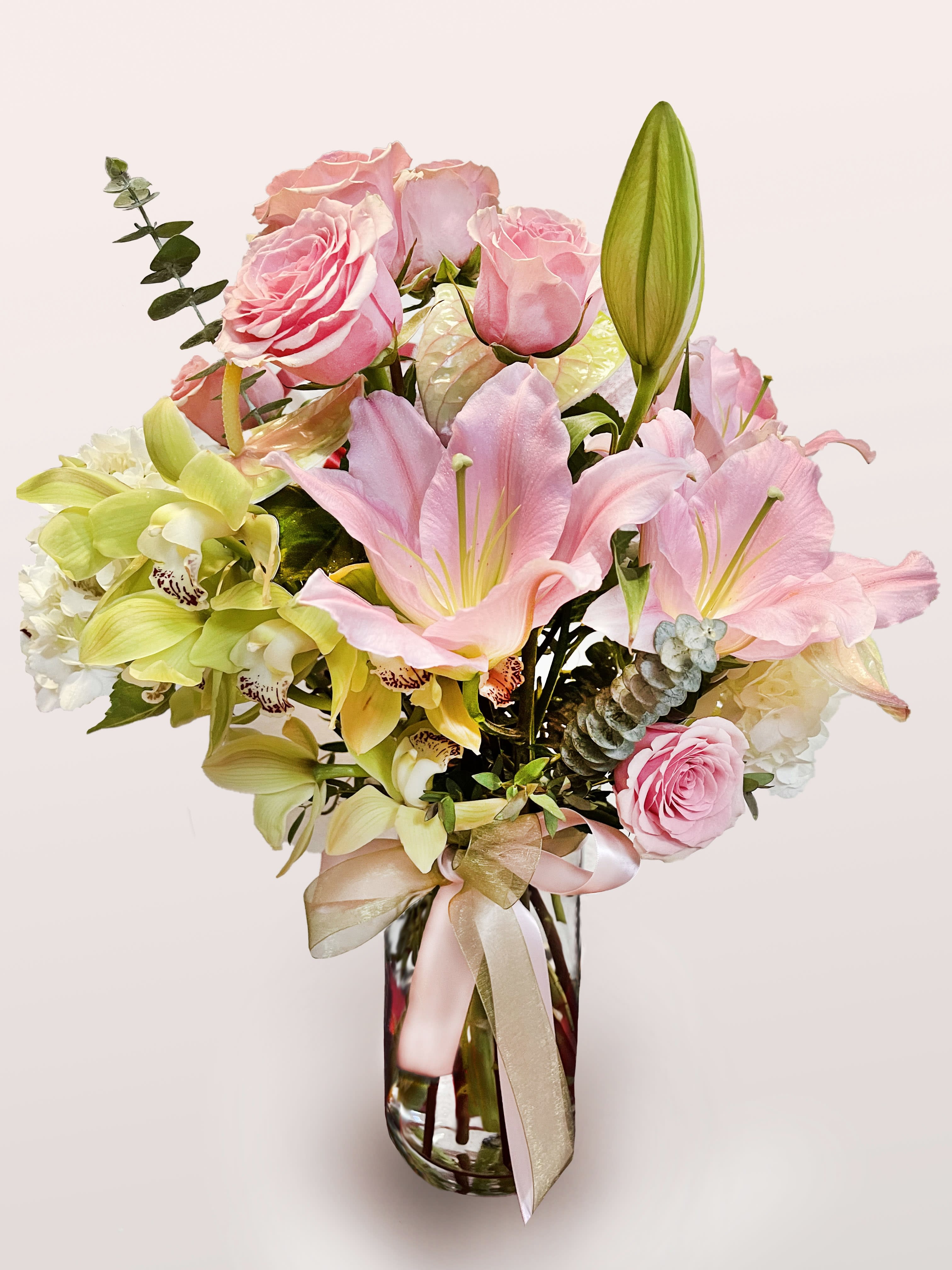 Sweet Elegance Sweet Elegance - A mix of traditional and tropical flowers combine to create "Sweet Elegance!" Features orchids, roses, lilies, and anthuriums in pink and green hues.