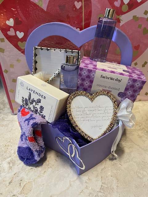 Favorite Day Gift Box - Give a festive lavender-themed gift box filled with lots of loving goodies! This one includes silver-tone heart earrings, bejeweled heart-shaped frame, chocolate truffles, cozy socks, luxury bath items, and notecards. All of this good stuff comes in a heart-shaped lavender box wrapped in cellophane and finished with a bow-- what a beautiful gift!