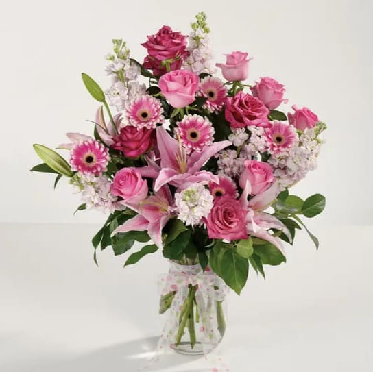 Awesome Anniversary - Show her how happy you are to have her in your life. A glass vase overflowing with favorite pink flowers for your forever-favorite girl. 