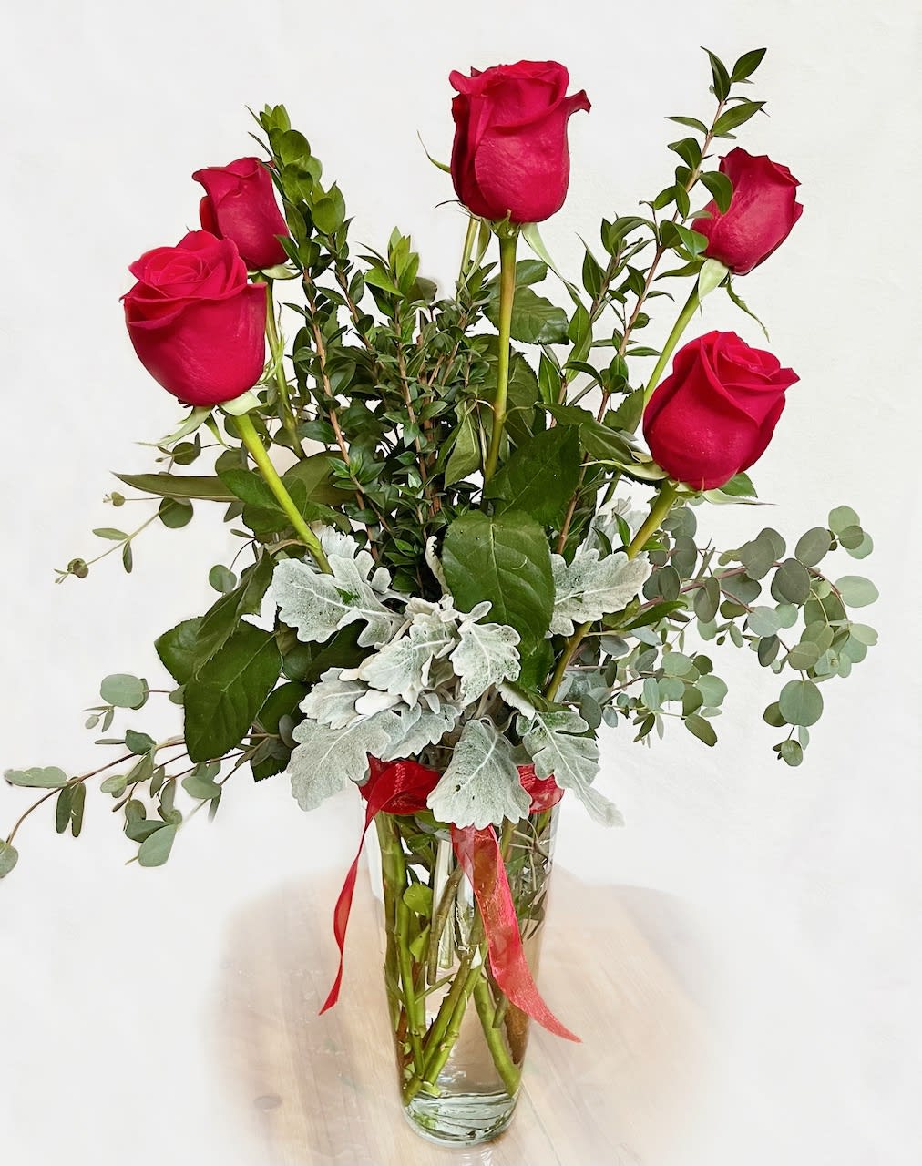 Six Red Roses in a Vase - Half a dozen beautiful red roses come arranged in a tall vase.