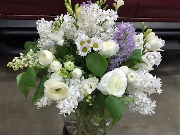Flowing and Floweree  - White Lilac, Purple Lilac, Ranunculus, Freesia, and Daisies. Note: Lilacs are seasonal to spring, so we will use flowers with similar feel during other times of the year.