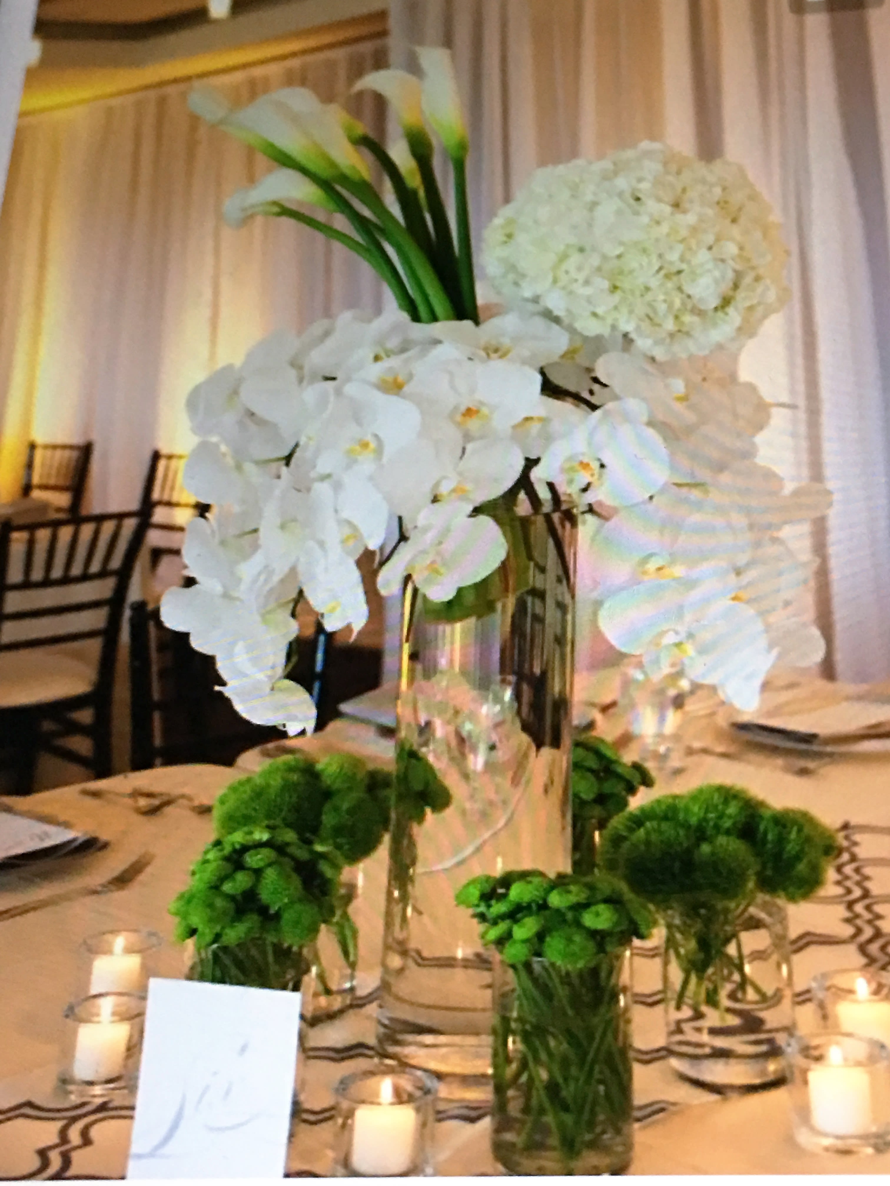 Pure and Classy - Tall and elegant arrangement with white calla lilies, white phalaenopsis orchids, and white hydrangea.
