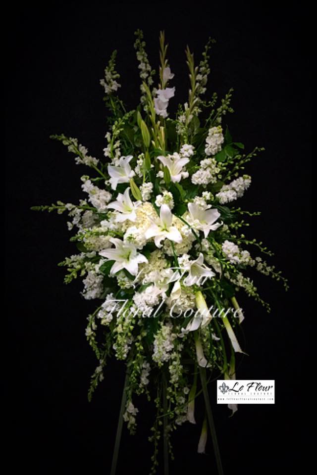 White Tribute Spray - A beautiful all white funeral spray consisting of gladiolas, snapdragons, stock, larkspur, hydrangeas, lilies and calla lilies. 