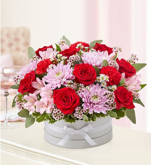 Sweet Love - ur gathering of red and pink blooms is arranged in our signature European hatbox: an elegant, new dove gray container finished with a matching ribbon.