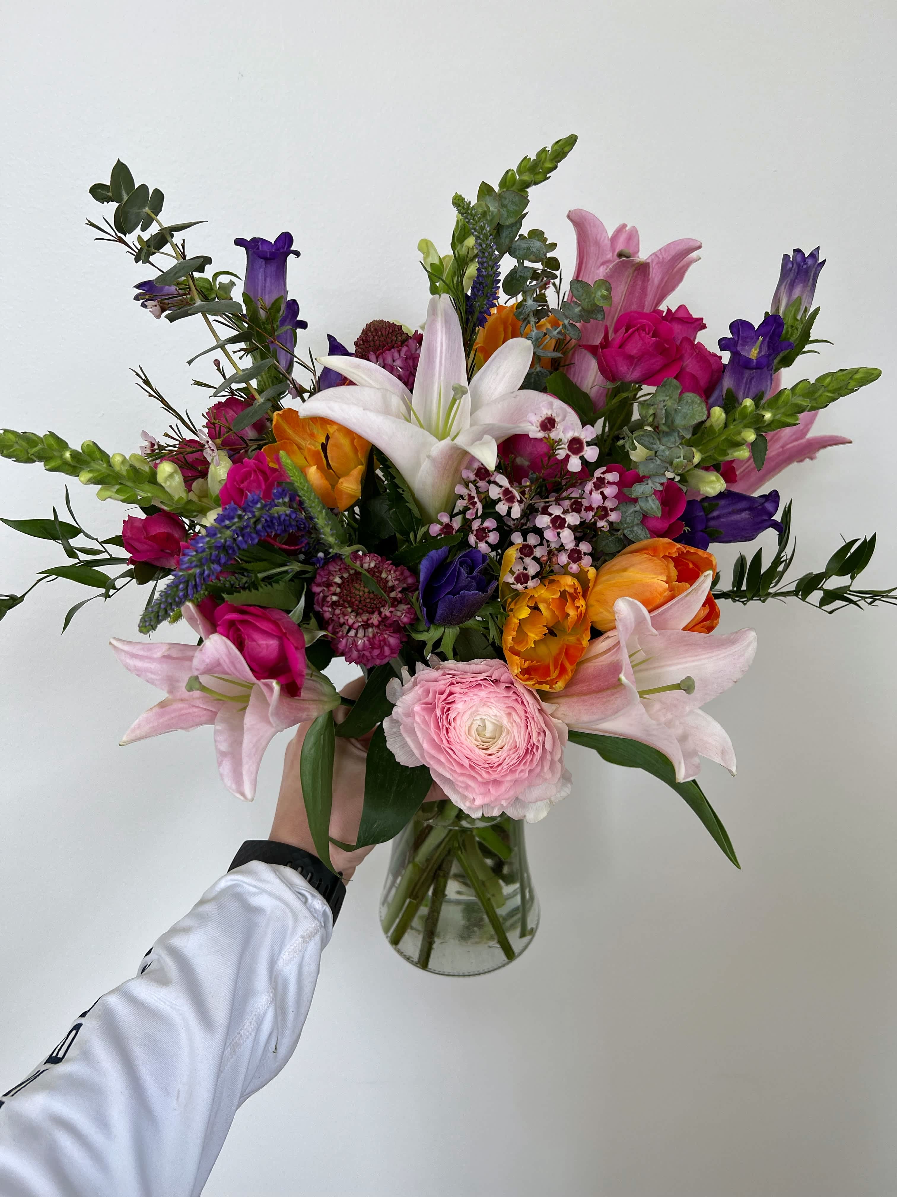 The Rachel - Meet “The Rachel”, an arrangement that will bring a smile to their face! Bright bold colors arranged tall with the freshest florals. 