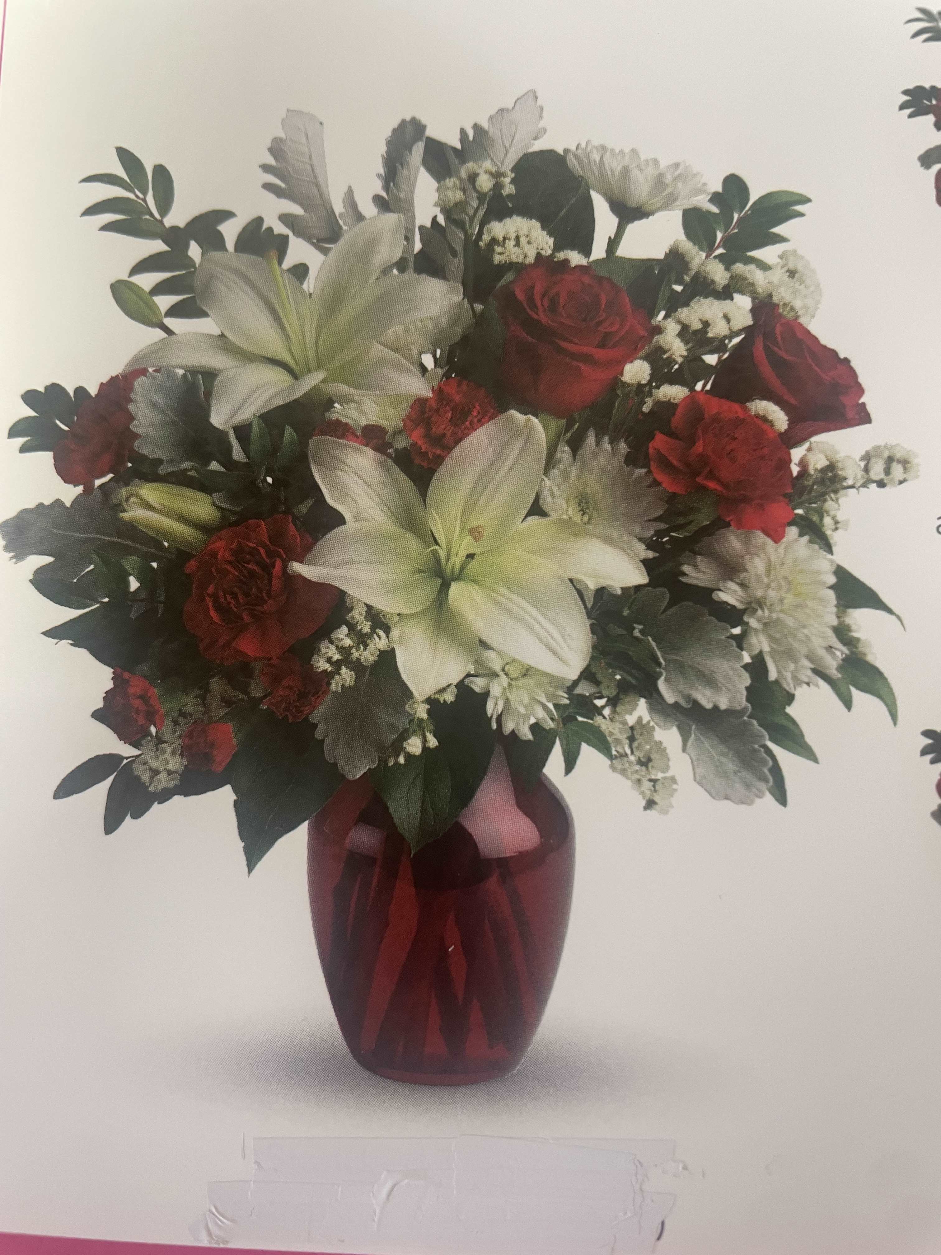 Love and Roses - This beautiful bouquet is great for Valentine's Day and your someone special.  Flowers and foliage are roses, carnations, lilies, chrysanthemums, huckleberry, lemon leaf, and others. Standard price is 79.99.  Custom made arrangements are higher prices.  We have them in premium and deluxe. For custom made arrangements please call the store. Seasonal flowers and foliage will be substituted.  
