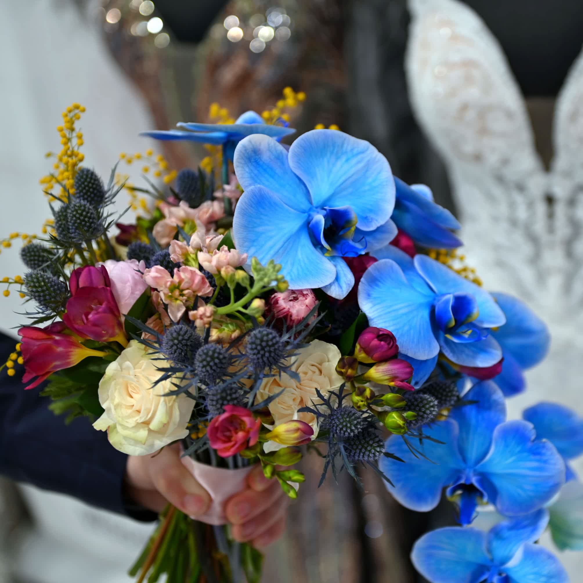 Blue Jasmine Orchid Bouquet  - Our blue orchid bouquet features stunning blue orchids arranged in a hand-tied style with complementary greenery or accent flowers. This unique and elegant bouquet adds a touch of exotic beauty to any occasion.   