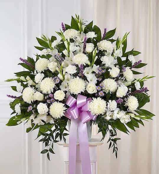 Lavender &amp; White Standing Basket - One who has touched the lives of many deserves to be honored in a uniquely touching way. Our majestic standing basket arrangement in lavender and white is an impressive tribute to their memory. Artistically designed by expert florists with an abundance of soft, lavender-hued and white blooms, it is a heartfelt expression of your deepest sympathies.