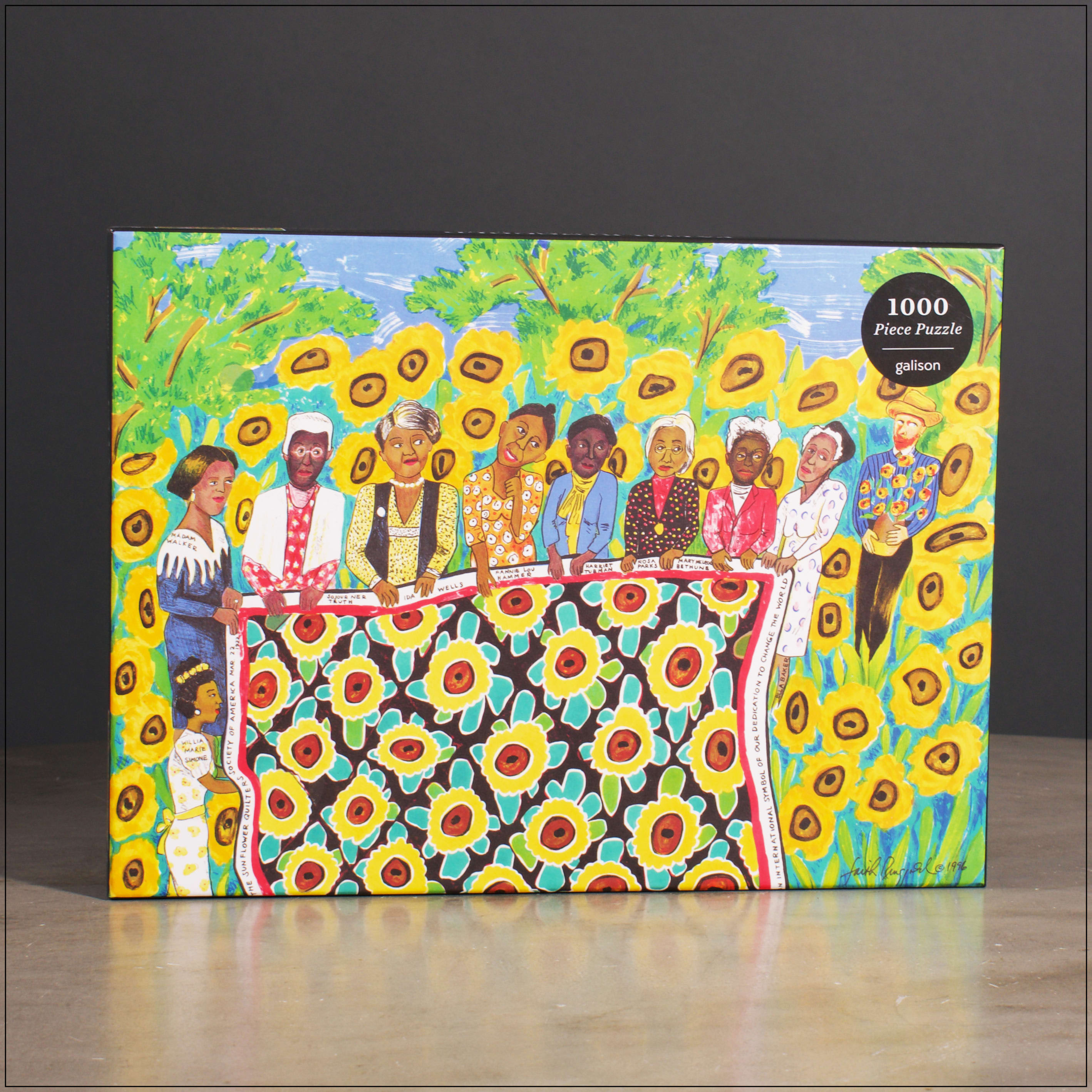 The Sunflower Quilting Bee at Arles 1000 Piece Puzzle - The Faith Ringgold The Sunflower Quilting Bee at Arles 1000 Piece Puzzle from Galison features Ringgold's colorful painting of eight powerful African American women from the past, including Sojourner Truth, Harriet Tubman, Rosa Parks, and more. Born 1930 in Harlem, New York, Ringgold is a painter, mixed media sculptor, performance artist, writer, teacher and lecturer. Through words and text, symbol and metaphor, she acknowledges the contributions of African American women and honors their traditions. Galison puzzles are packaged in matte-finish sturdy boxes, perfect for gifting, reuse, and storage. An insert of the full puzzle image is also included.  - 1000 pieces