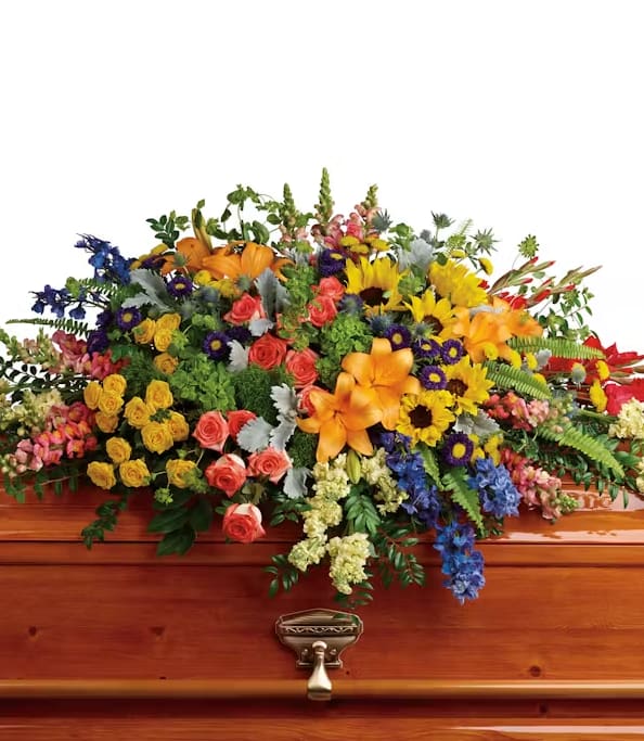Glorious Glorious - Every flower and color imaginable is included in this tribute- roses, sunflowers, delphiniums, snapdragons, gladiolas, hydrangeas, stock, thistle, fern- to name a few. (Note: Arrangement will be filled with the highest quality, freshest flowers available to the value of the order and therefore flower substitutions may be necessary.)