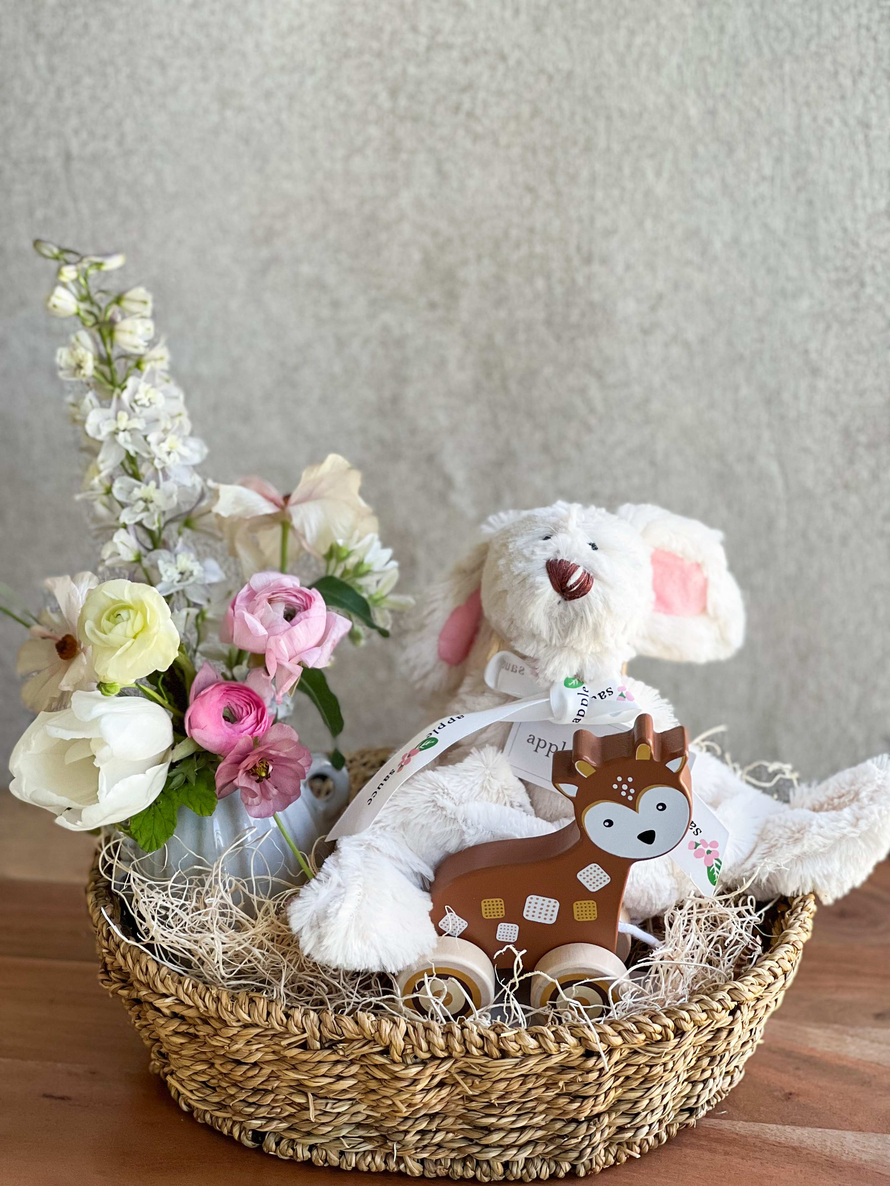 Sweet Baby Gift Set  - A delicate small floral arrangement, a Wooden Deer Pull Toy, a White bunny stuffie (12 inches) an oval seagrass tray, and a handwritten card.   Please call our shop if you would like to customize the arrangement.      Call our shop for custom orders. 