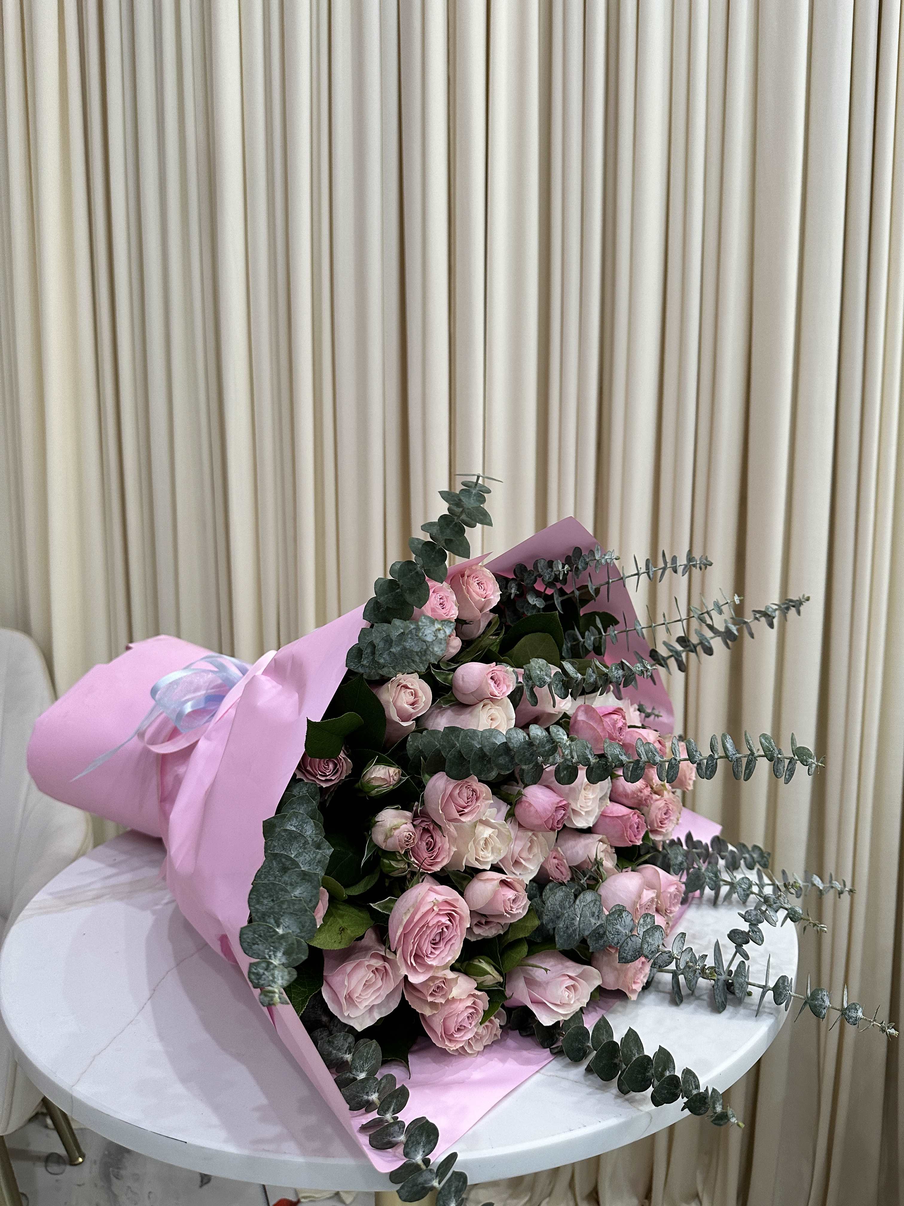 Pink Blush and Baby Dream Bouquet - This enchanting bouquet combines the elegance of pink roses with the delicate charm of baby pink roses and eucalyptus. The soft, romantic coloring of the roses is perfectly complemented by the refreshing greenery of eucalyptus, creating a timeless and delightful arrangement.